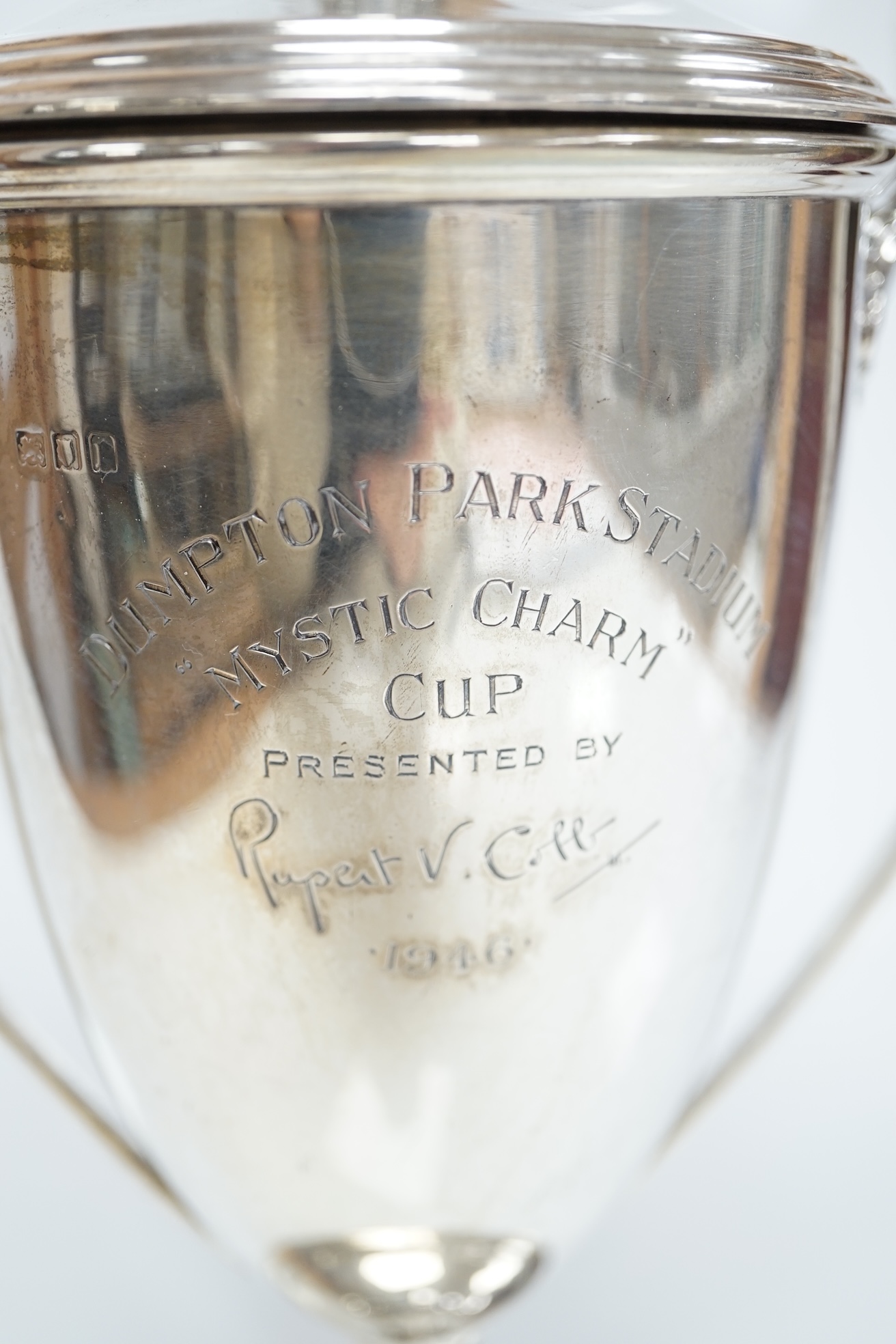 A George V silver two handled presentation trophy cup and cover, 'Dumpton Park Stadium Cup', Edward Barnard & Sons Ltd, London, 1920, 27.8cm, 15.1oz. Condition - poor to fair